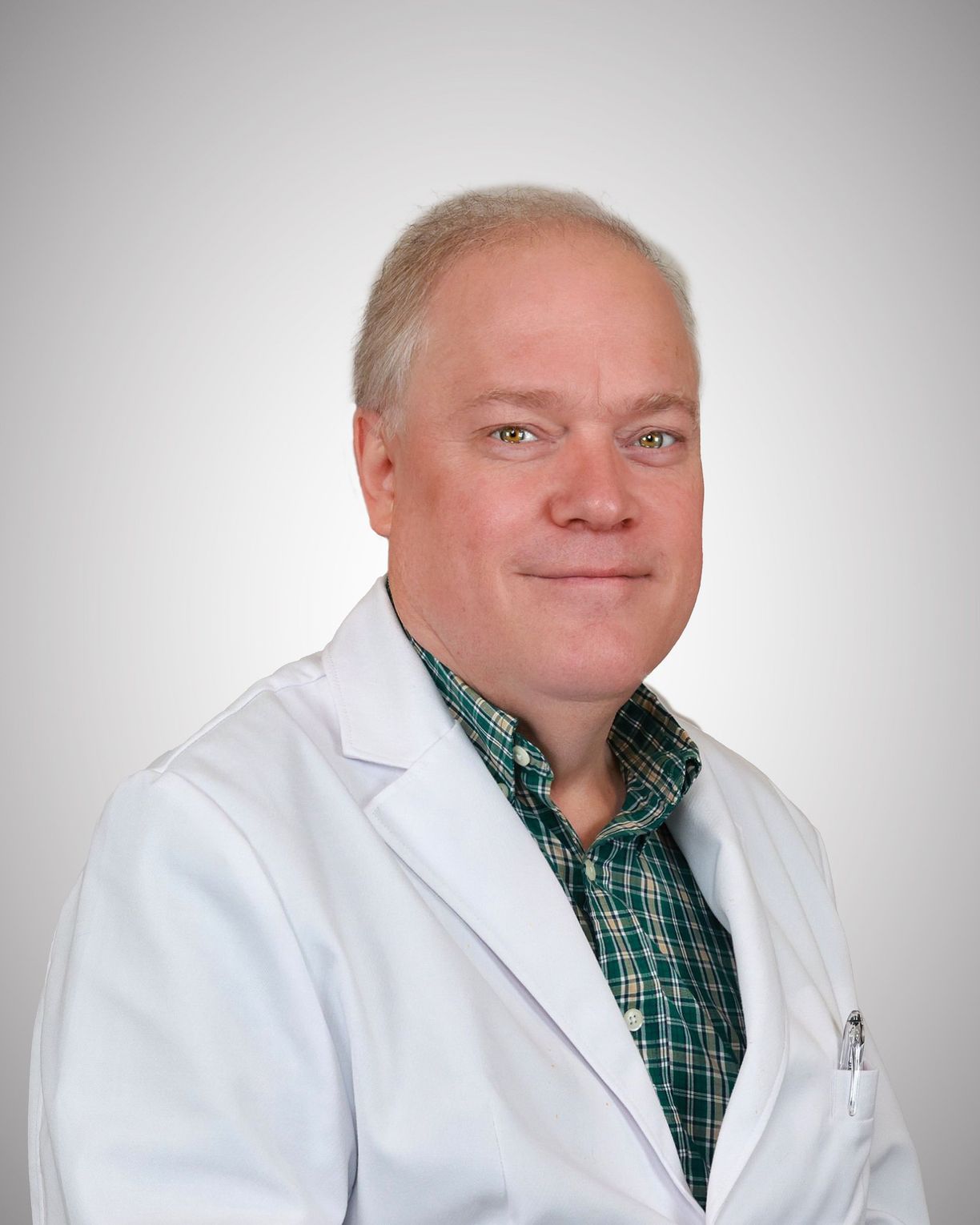 Portrait of Mark Hoskinson, MD, in a white coat